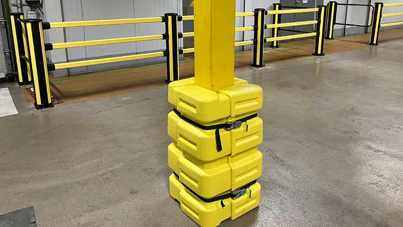 yellow column guard protecting a pillar in industrial environment